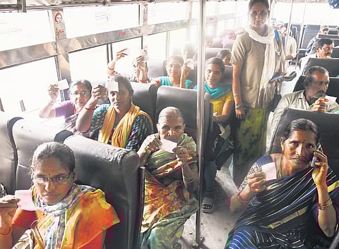Commuters display ‘zero tickets’ aboard a TGSRTC bus on Wednesday