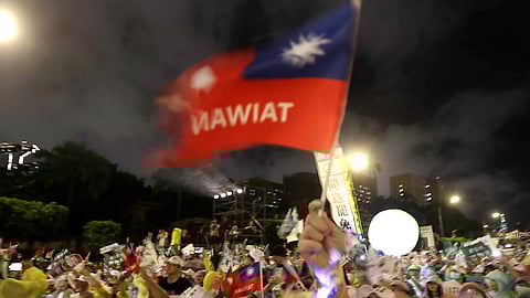 People wave a Taiwan national flag during a campaign rally to promote recall vote targeting 24 Nationalist Party (KMT) lawmakers in Taipei, Taiwan, Thursday, July 24, 2025.