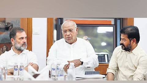 Leader of the Opposition in the Lok Sabha Rahul Gandhi and AICC chief Mallikarjun Kharge listen as Chief Minister A Revanth Reddy speaks in New Delhi on Thursday