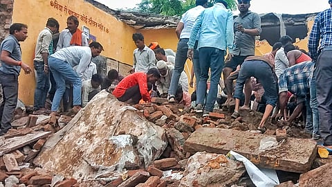 Locals during the rescue work after a government school building collapsed, in Jhalawar district, Rajasthan, Friday, July 25, 2025.