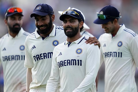 India's Jasprit Bumrah, second left, and Ravindra Jadeja walks off the field