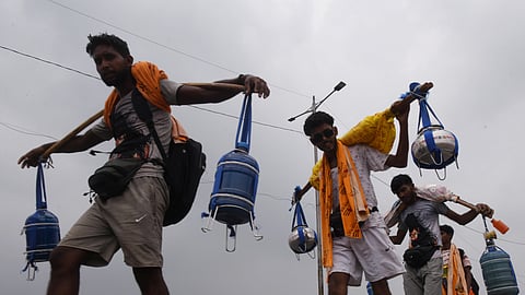 Kanwariyas return carrying Ganga water during the annual 'Kanwar Yatra.'