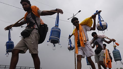 Kanwariyas return carrying Ganga water during the annual 'Kanwar Yatra.'