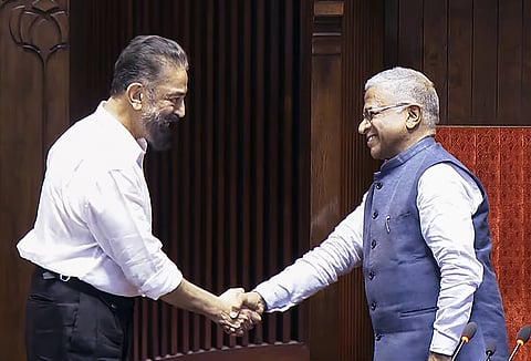 MNM, MP Kamal Haasan and Deputy Speaker Harivansh Narayan Singh greets each other during oath ceremony in Rajya Sabha in Monsoon Session of Parliament, in New Delhi on Friday.
