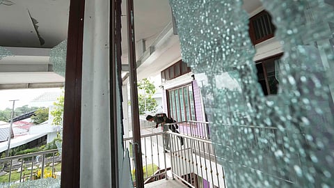 A Thai soldier stands at the Phanom Dong Rak hospital damaged after Cambodia fired artillery shells in Surin Province, Thailand, Friday, July 25, 2025.
