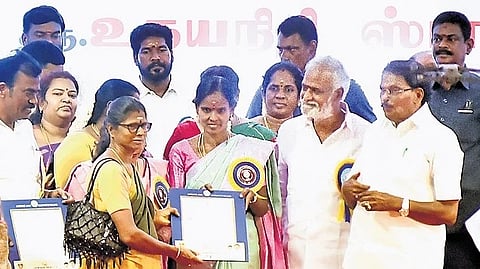 Ministers KKSSR Ramachandran and PK Sekarbabu giving away pattas in Ambattur on Friday.