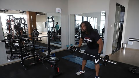 Kenneth Harris, a 38-year-old retired veteran, lifts weights at a gym in Nairobi, Kenya, Friday, May 23, 2025.