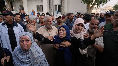 Marwa Barakat, center, mourns during the funeral of her son Fahd Abu Hajeb, 36, who was killed while trying to reach aid trucks entering northern Gaza through the Zikim crossing with Israel, at Shifa Hospital, in Gaza City, Saturday, July 26, 2025.