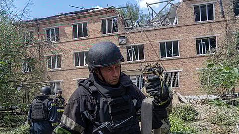 Rescuers work at a damaged city hospital that was hit by a Russian guided air bomb in Kharkiv, Ukraine, Friday, July 25, 2025.