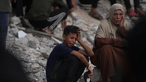 Palestinians mourn during the funeral of people who were killed while trying to reach aid trucks entering northern Gaza through the Zikim crossing with Israel, at Shifa Hospital, in Gaza City, Saturday, July 26, 2025.