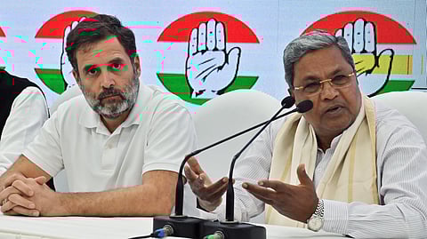 Karnataka Chief Minister Siddaramaiah addresses a press conference with Congress leader Rahul Gandhi at the party headquarters in New Delhi.
