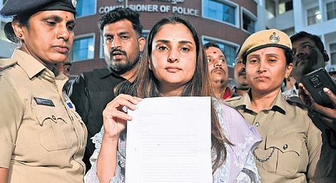 Ramya shows her petition submitted to the police commissioner
on Monday