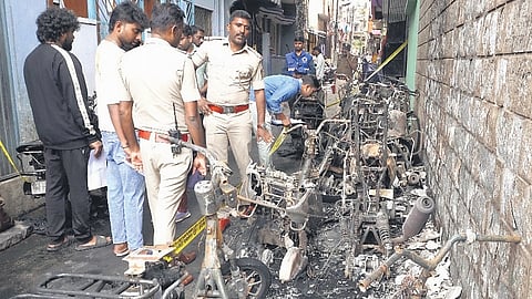 Police inspect the scene of arson wherein ten two-wheelers were set on fire by three miscreants on Bajaj Street near Halasuru market early on Monday morning