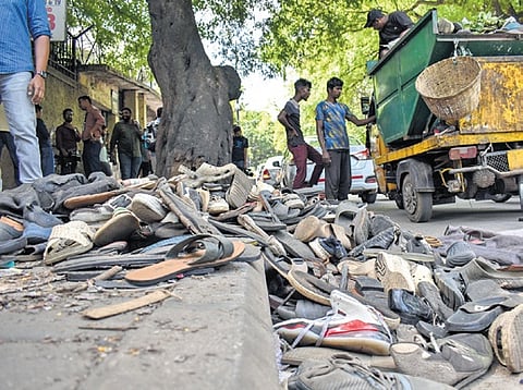 In this June 4, 2025 file photo, footwear lie on the ground outside the Chinnaswamy Stadium following a stampede during RCB's victory celebrations.