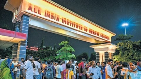 The victim and other contractual workers protest in front of AIIMS-BBS main gate.