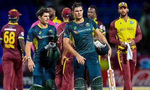 Sean Abbott (L) and Aaron Hardie (2L) of Australia walk off the field after winning the fifth and final Twenty20 (T20) international cricket match between West Indies and Australia at Warner Park Sporting Complex in Basseterre, Saint Kitts and Nevis, on July 28, 2025.