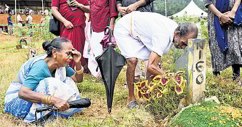 Pandiyan‘s mother Pappathi crying when she realised a wrong memorial stone was placed at the grave as her husband Palaniswamy cleans the area.