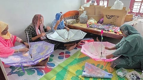 Sajna, Naseema, Ramlath and Fathima make umbrellas at their unit in Meppadi.