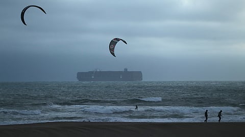 During a tsunami advisory triggered by an underwater earthquake off the coast of Russia, a pair of kite surfers recreate near two beach walkers at Ocean Beach in San Francisco on Tuesday, July 29, 2025.