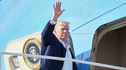 US President Donald Trump waves as he boards Air Force One, Tuesday, July 29, 2025, at Royal Air Force Lossiemouth en route to return to Washington.