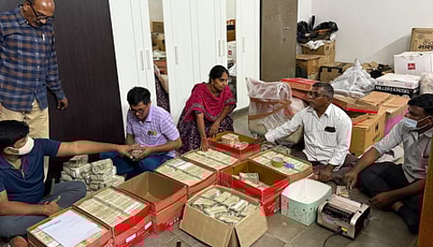 The Special Investigation Team (SIT), probing the alleged multi-crore liquor scam, has seized Rs 11 crore in cash stored in 12 cardboard boxes from a farmhouse in Telangana.