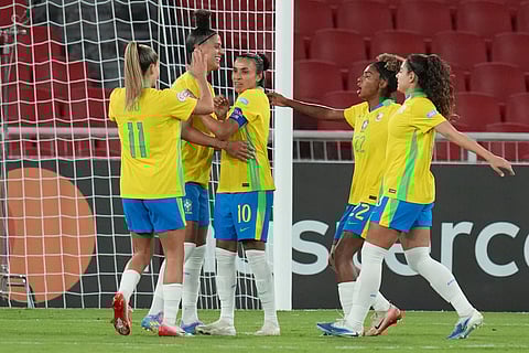 Brazil's Marta, center, celebrates with teammates after scoring her side's third goal against Uruguay, from the penalty spot, during a Women's Copa America soccer semifinal on Tuesday, July 29, 2025.