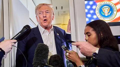 US President Donald Trump speaks with reporters aboard Air Force One after leaving Aberdeen, Scotland, Tuesday, July 29, 2025, en route to Washington.
