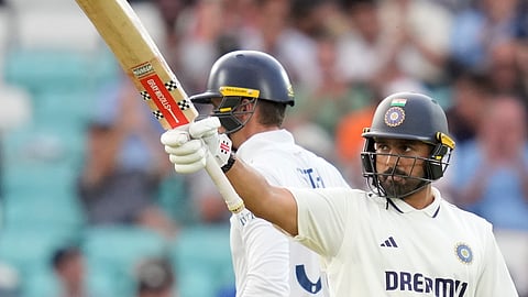 India's Karun Nair celebrates his half century during the first day of the fifth Test cricket match between India and England.