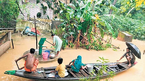 Residents of Gopalpur village take a boat to collect water from a tubewell.