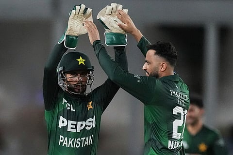 Pakistan's Mohammad Nawaz, right, celebrates with teammate after the dismissal of West Indies' Johnson Charles during the first Twenty20 cricket match between West Indies and Pakistan, in Lauderhill, Fla., Thursday, July 31, 2025.