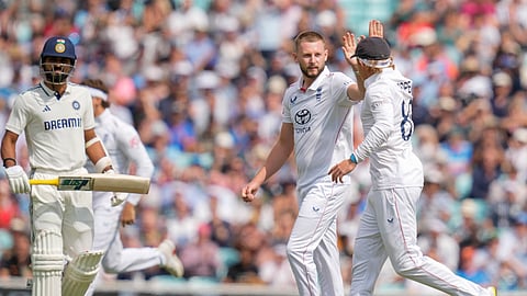 England's bowler Gus Atkinson celebrates with teammate after taking the wicket of India's batter Prasidh Krishna on the second day of the fifth Test cricket match between India and England, at the Oval.