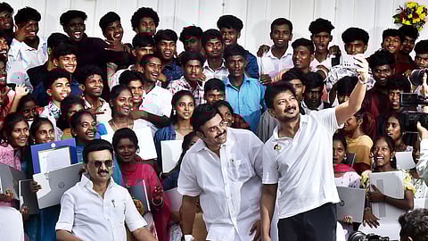 Deputy CM Udhayanidhi Stalin taking a selfie with CM Stalin and 136 students from Adi Dravidar and Tribal Welfare schools who have secured admission to premier higher education institutions across the country.