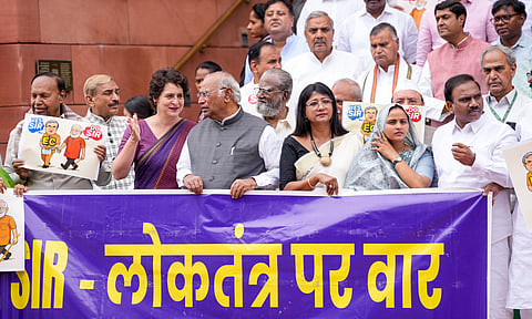 Congress MPs Mallikarjun Kharge and Priyanka Gandhi Vadra, DMK MP TR Baalu, JMM MP Mahua Maji and other parliamentarians of the INDIA bloc parties stage a protest against the Election Commission's Special Intensive Revision (SIR) of electoral rolls in Bihar, during the Monsoon session of Parliament, in New Delhi.