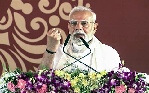 Prime Minister Narendra Modi addresses the gathering during the laying of the foundation stone and inauguration of multiple development projects worth around Rs 2,200 crore, in Varanasi on Saturday.