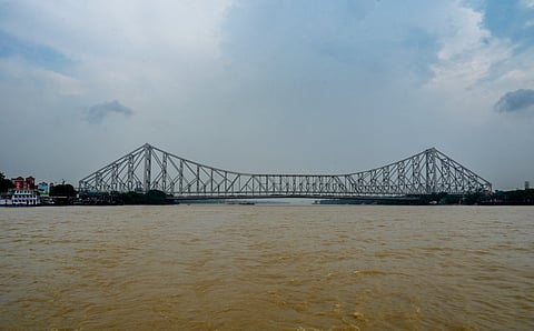 The Ganga river flows in spate during the monsoon season as it passes under the Howrah Bridge, in Kolkata, West Bengal, Sunday, Aug. 3, 2025.
