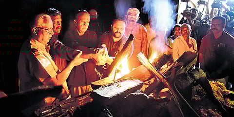M S Renjith and M S Harris, sons of M K Sanoo, light the pyre at Ravipuram crematorium
