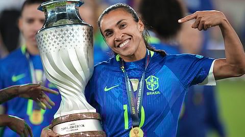 Brazil's Marta holds the trophy after winning the Women's Copa America final soccer match against Colombia in a penalty shootout at Rodrigo Paz Delgado stadium in Quito, Ecuador, Saturday,