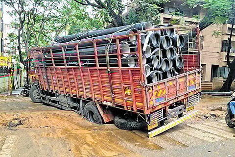 A truck carrying Bangalore Water Supply and Sewerage Board pipes stuck in slush caused by delayed civic works in Malleswaram on Monday morning. The overnight rain rendered the soil soft, causing the truck’s wheels to sink deep.