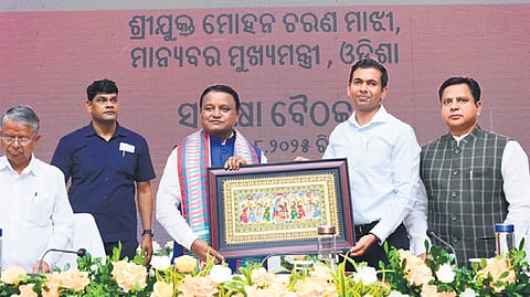 CM Mohan Majhi being presented a memento during the review meeting on Sunday.