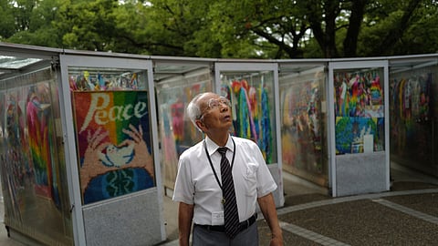 Kunihio Iida, an atomic bomb survivor and a volunteer guide, looks on at the Children's Peace Monument, the place where people offer paper cranes to honour the victims of the 1945 atomic bomb, on Wednesday, July 9, 2025, in Hiroshima, western Japan.