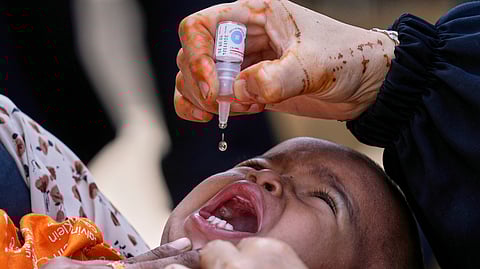 A health worker administers a polio vaccine to a child in Karachi, Pakistan, April 21, 2025.