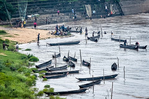 People fishing in the floodwaters of Mahanadi at Mundali barrage in Cuttack