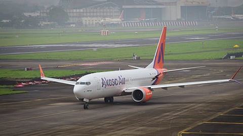 Passenger detained for trying to open emergency exit on flight.