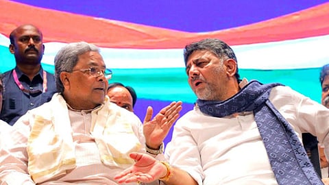 Karnataka Chief Minister Siddaramaiah (L) in conversation with his deputy and state Congress chief DK Shivakumar.