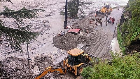 An excavator being used to clear debris from a road following flash floods triggered by a cloudburst, near Harsil in Uttarkashi district, Uttarakhand, Wednesday, Aug. 6, 2025.