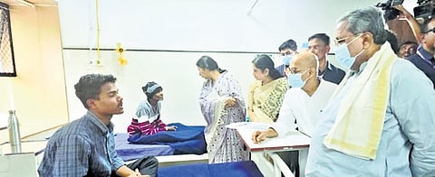 CM Siddaramaiah, accompanied by Medical Education Minister Dr Sharan Prakash Patil, interacts with a patient in Victoria Hospital, Bengaluru, on Wednesday