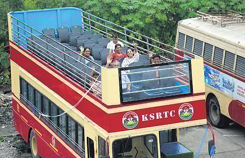 The open-top double decker bus, conducting city tour trips, awaits visitors at the Ernakulam bus station