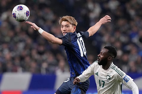 Japan's Ritsu Doan, left, and Saudi Arabia's Hassan Al Tambakti battle for control the ball during the World Cup 2026 group C qualifying soccer match between Japan and Saudi Arabia at Saitama Stadium 2002 in Saitama, north of Tokyo, March 25, 2025.