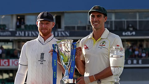 England's captain Ben Stokes (L) and Australia's captain Pat Cummins (R) hold the Series trophy after the drawn Ashes Series, after England's victory on day five of the fifth Ashes cricket Test match between England and Australia at The Oval cricket ground in London on July 31, 2023.