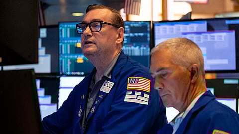 raders work on the floor of the New York Stock Exchange, Friday, Aug. 1, 2025, in New York